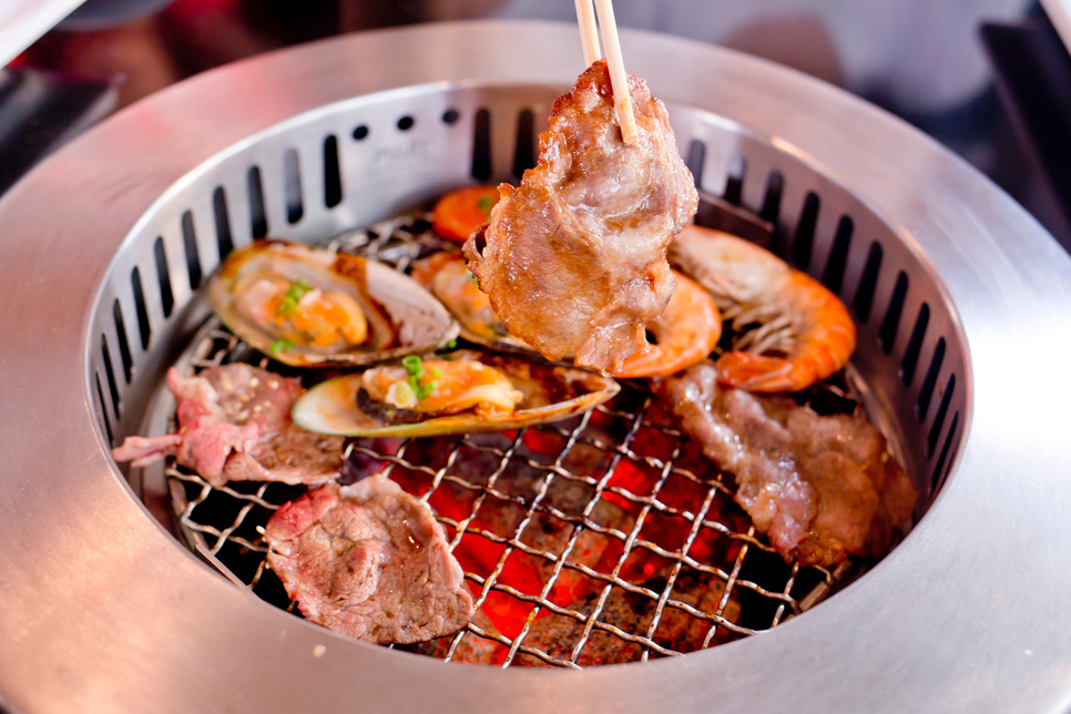 Mixed Roasted Meat and Seafood and Chopsticks on the BBQ